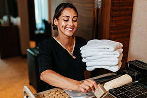 housekeeper holding towels